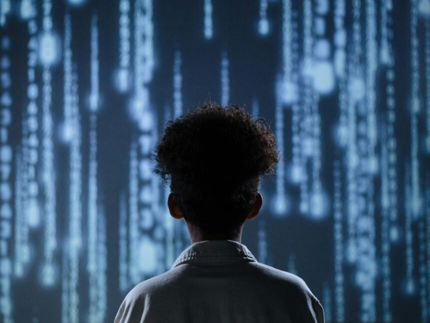 A child standing in front of a digital screen