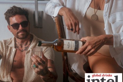 A man being poured a drink from a bottle of Ilegal mezcal