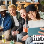 Four younger LDA consumers posing for a selfie holding drinks
