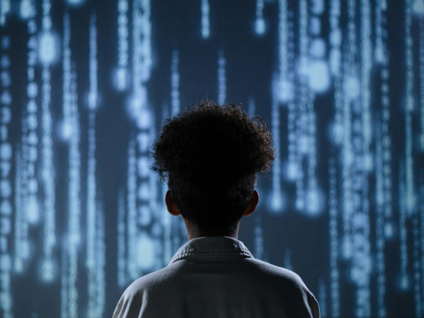 A child standing in front of a digital screen
