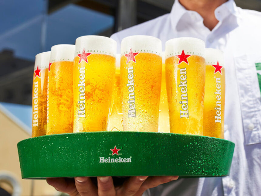 Branded glasses of Heineken on a tray