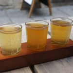 Three glasses of cider on a tasting tray