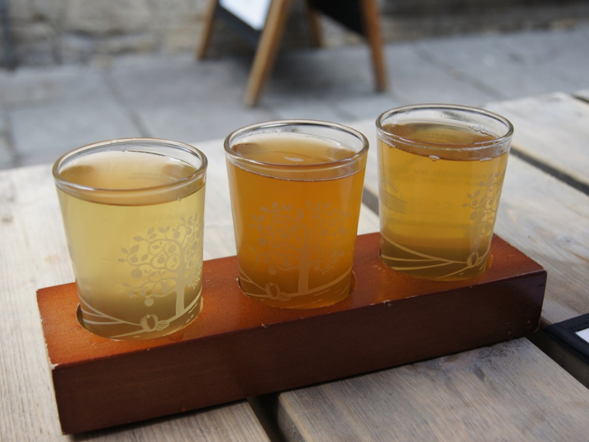 Three glasses of cider on a tasting tray