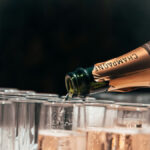 Bottle of champagne poured into a glass