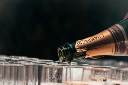 Bottle of champagne poured into a glass