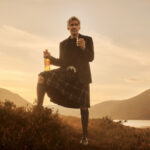 Harrison Ford in Scottish highlands with Glenmorangie whisky bottle and glass