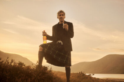 Harrison Ford in Scottish highlands with Glenmorangie whisky bottle and glass