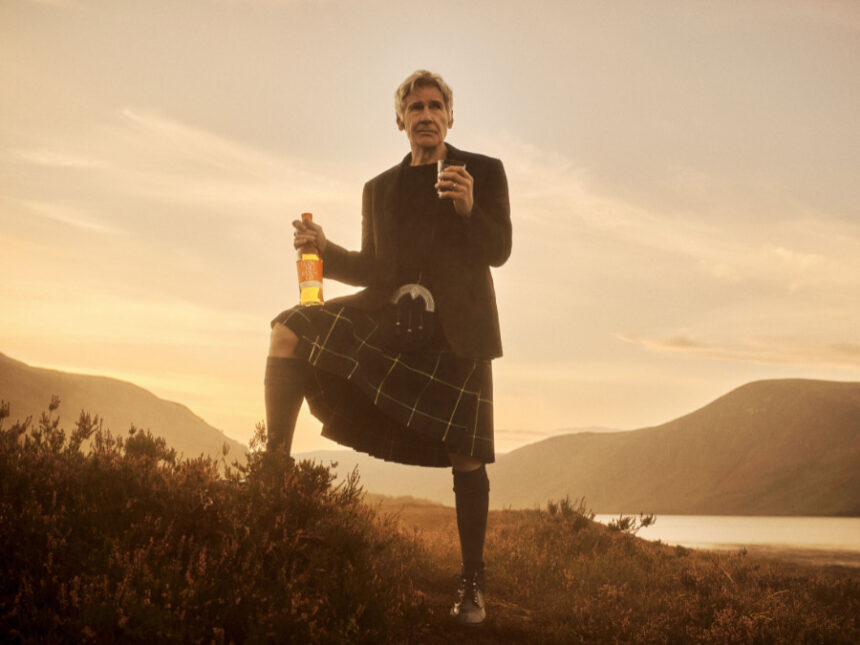 Harrison Ford in Scottish highlands with Glenmorangie whisky bottle and glass