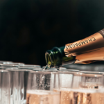 Bottle of champagne poured into a glass