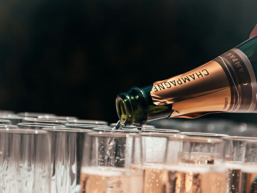 Bottle of champagne poured into a glass
