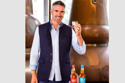 Kevin Pietersen with bottles of Dram Bell blended scotch whisky