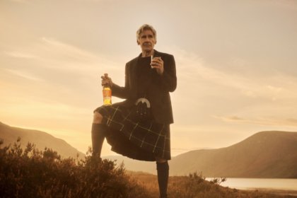 Harrison Ford in Scottish highlands with Glenmorangie whisky bottle and glass