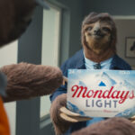 A sloth holds limited edition Coors Light case of beer in advert