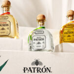 Three Patron tequila bottles on steps