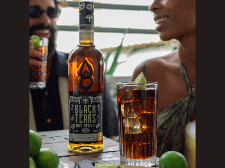 Bottle of Black Tears Dry Spiced Rum with a cuba libre serve