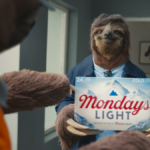 A sloth holds limited edition Coors Light case of beer in advert