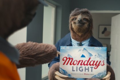 A sloth holds limited edition Coors Light case of beer in advert