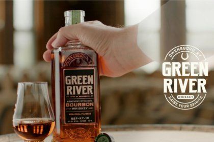Green River whiskey bottle held by ghost's hand next to serve