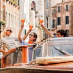 Three people raising glasses on a boat
