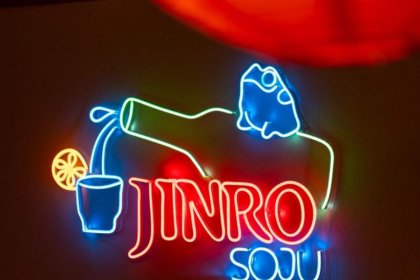 Neon sign with bottle pouring Jinro Soju and writing