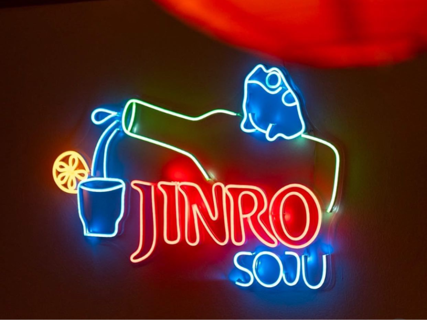 Neon sign with bottle pouring Jinro Soju and writing