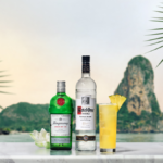 Ketel One and Tanqueray bottles with White Lotus punch cocktail