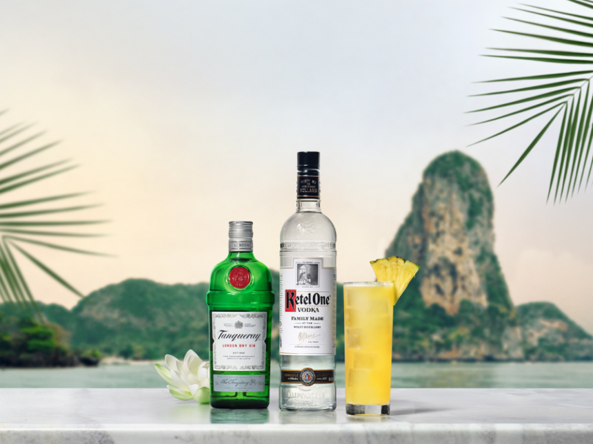 Ketel One and Tanqueray bottles with White Lotus punch cocktail