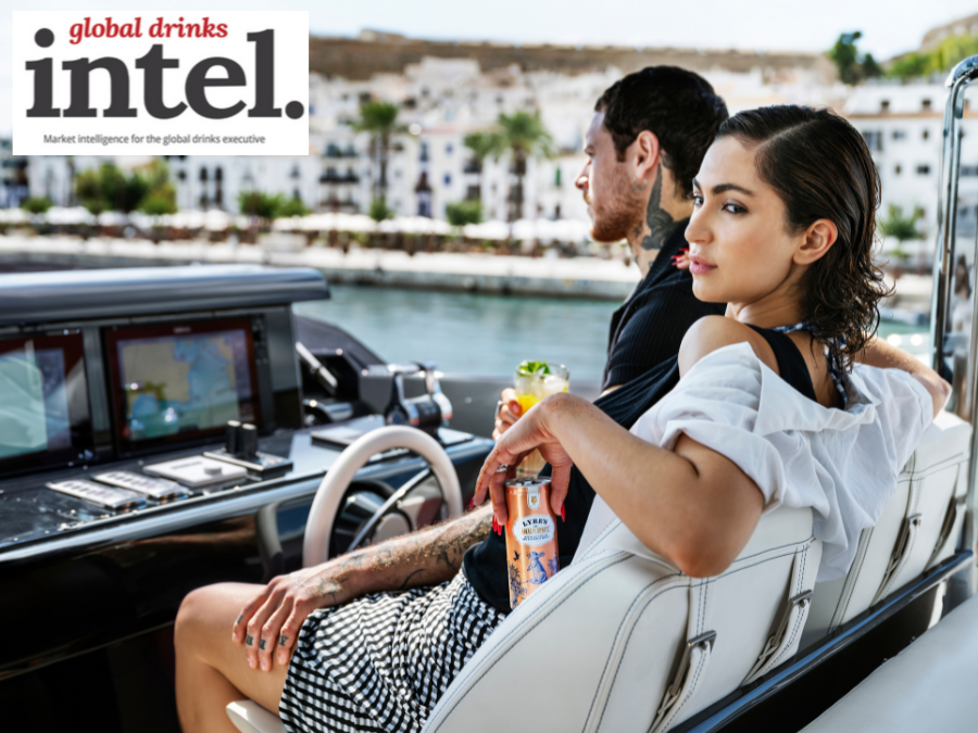 A man and a woman on a boat holding a can of Lyre's non-alcoholic premix cocktail