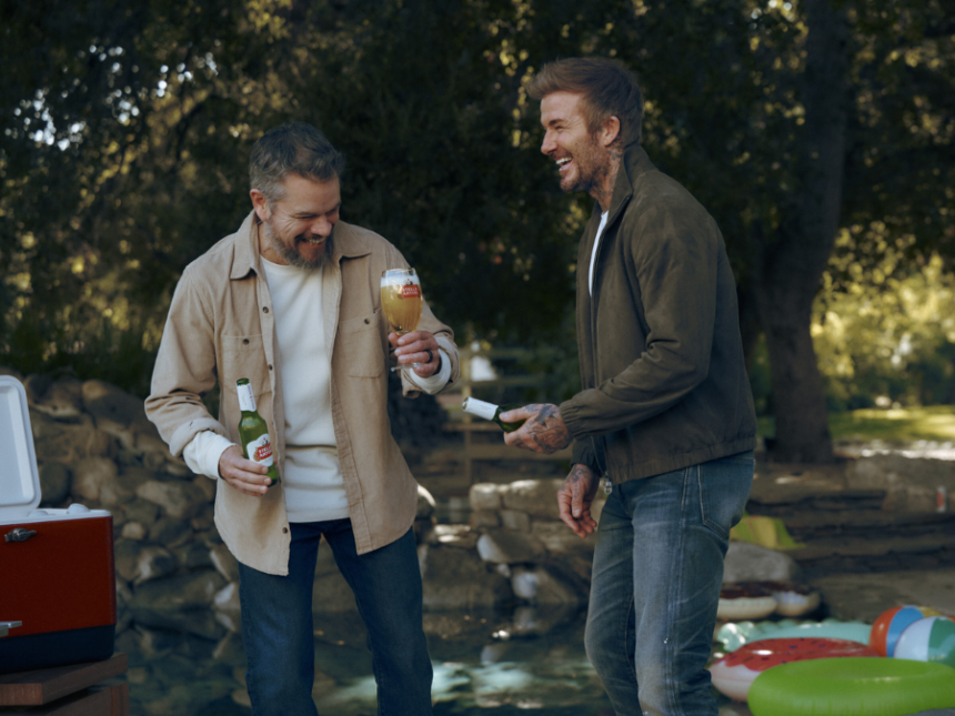 Matt Damon and David Beckham laughing with Stella Artois beer