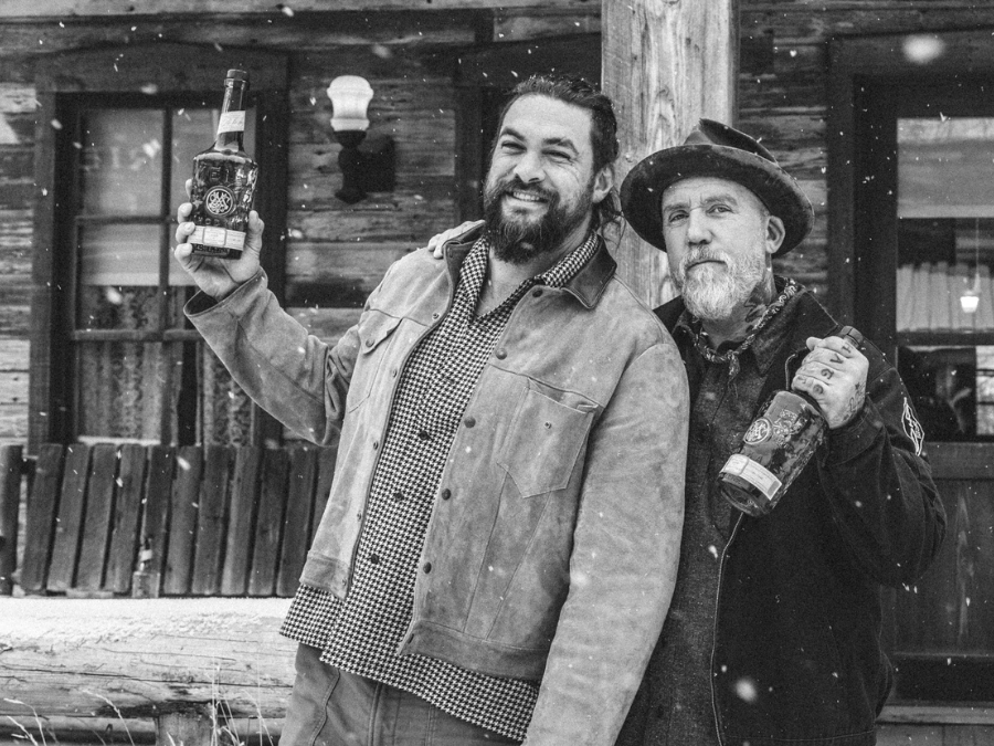 US actor Jason Momoa and brand creator Blaine Halvorson with Meili vodka bottles
