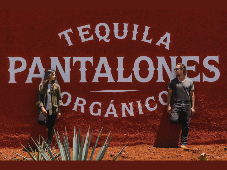 Camila and Matthew McConaughey in front of Pantalones tequila sign