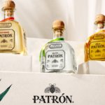 Three Patron tequila bottles on steps