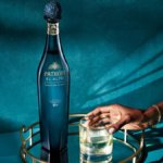 Patron El Alto bottle next to full sipping glass