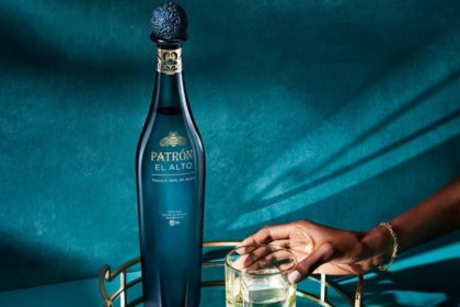 Patron El Alto bottle next to full sipping glass