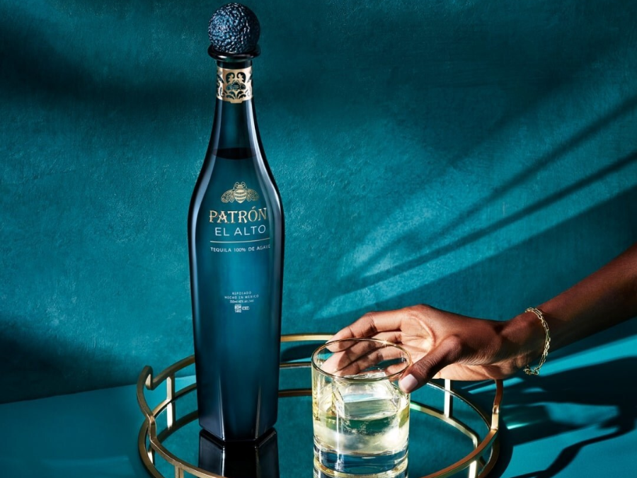 Patron El Alto bottle next to full sipping glass
