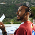 Lewis Hamilton holding Peroni invitation