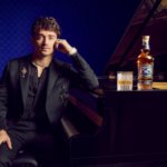 Charles Leclerc next to piano with Chivas Regal bottle and serve