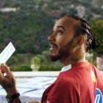 Lewis Hamilton holding Peroni invitation