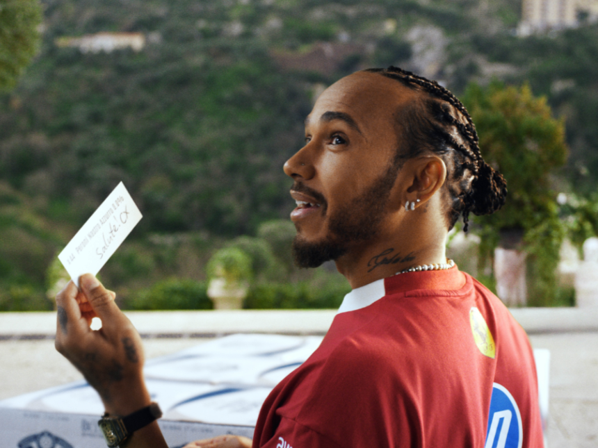 Lewis Hamilton holding Peroni invitation