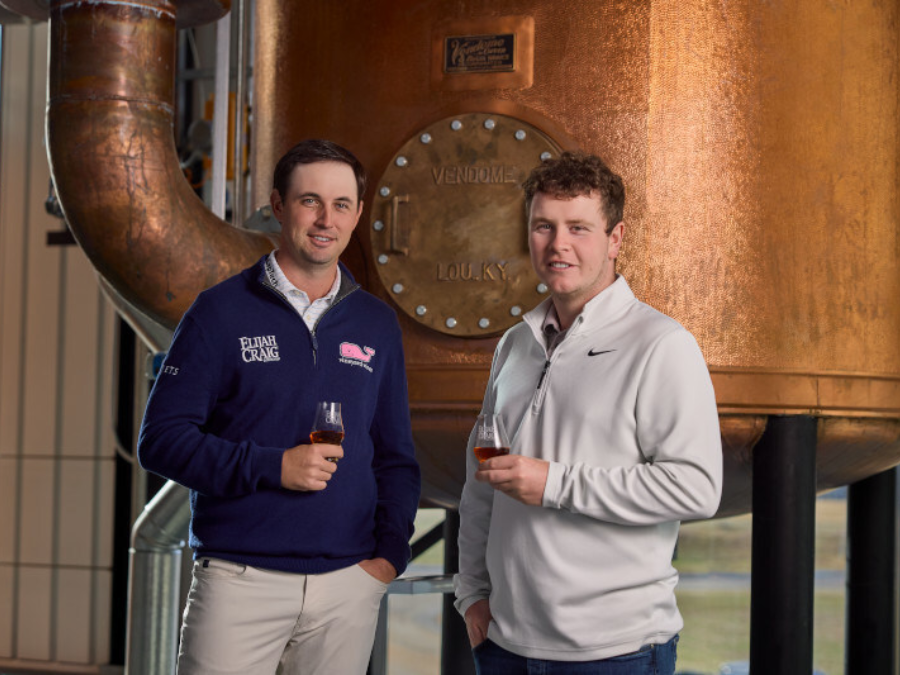 J.T. Poston and Robert MacIntyre in distillery holding whiskey serves