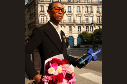 Pharrell Williams holding Moet & Chandon bottle and bunch of flowers