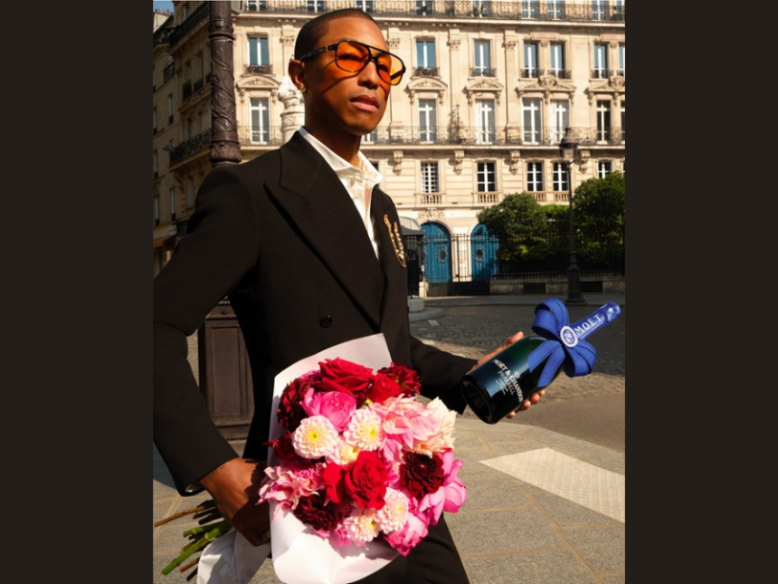Pharrell Williams holding Moet & Chandon bottle and bunch of flowers