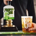 Proper Job IPA pint serve next to tap