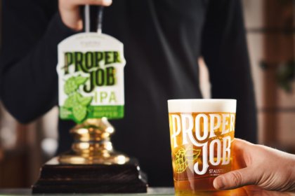 Proper Job IPA pint serve next to tap