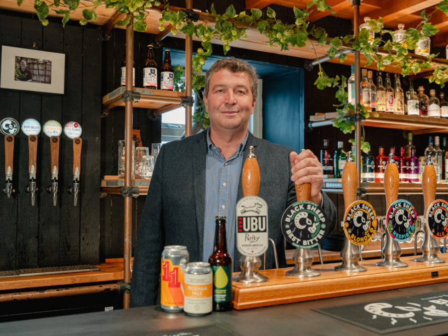 Steve Cox next to beer pumps