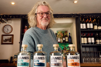 James May next to lineup of James Gin bottles