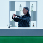 Bartender preparing cocktails with Tanqueray bottle on the bar