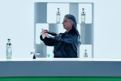Bartender preparing cocktails with Tanqueray bottle on the bar
