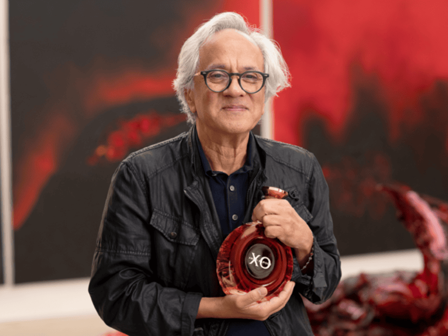 Anish Kapoor holding his limited-edition bottle