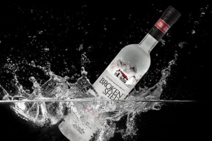 Broken Shed vodka bottle splashing in water